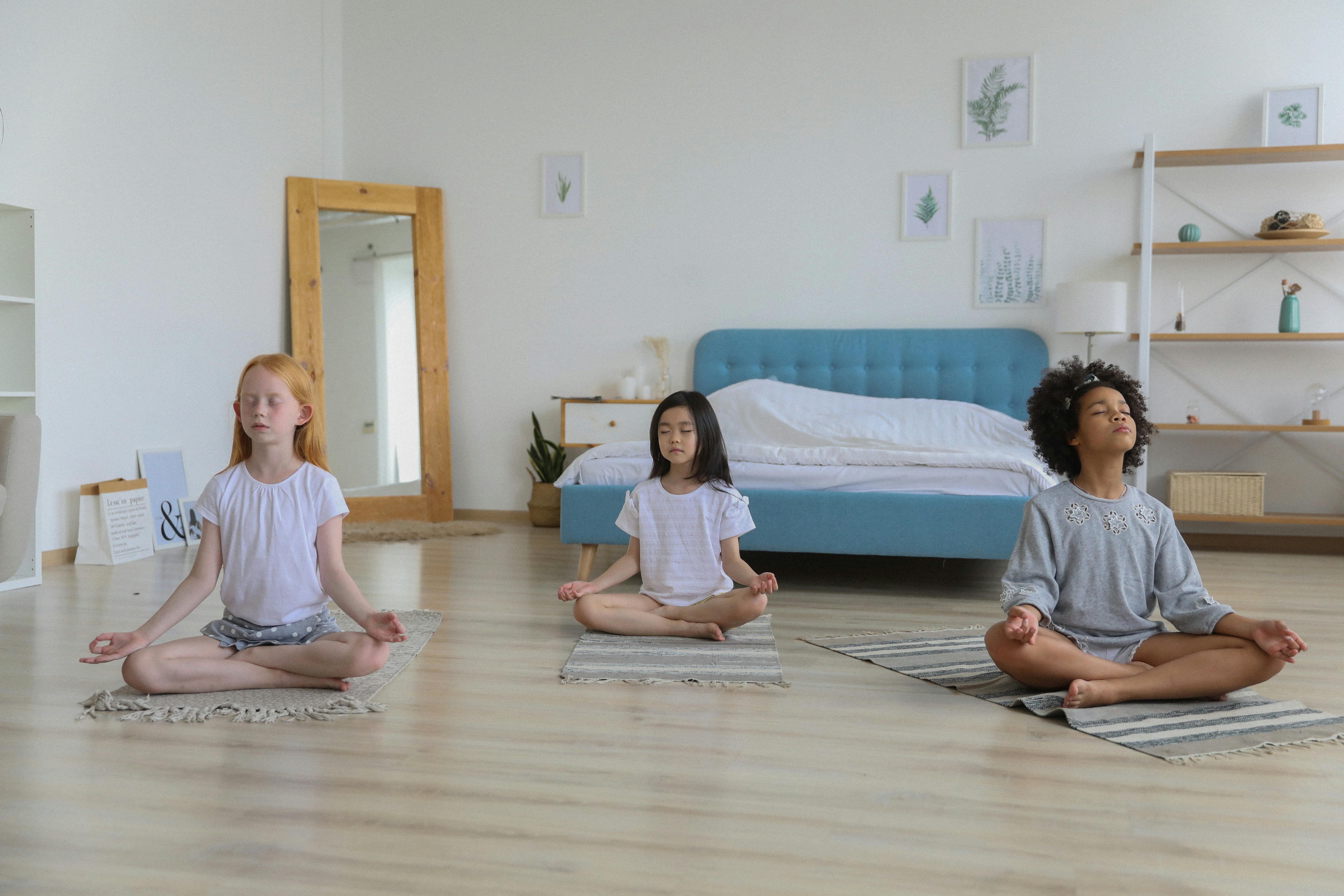 Children practicing yoga and mindfulness activities to improve focus, emotional regulation, and overall well-being